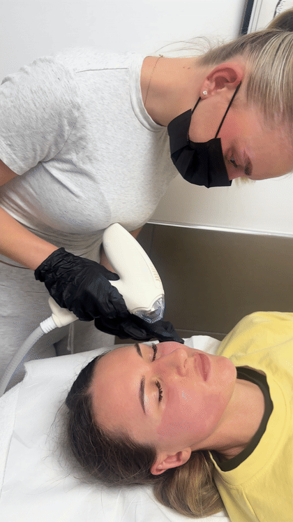 Practitioner performing a facial treatment